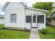Cozy home featuring a white-framed door and a quaint entrance with small steps leading up to the front door at 2012 George St, Anderson, IN 46016