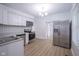 Bright kitchen features white cabinets, stainless steel appliances, and updated flooring at 2012 George St, Anderson, IN 46016