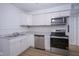 Modern kitchen showcasing stainless appliances, white cabinetry, and tiled backsplash at 2012 George St, Anderson, IN 46016