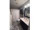 This bathroom has gray flooring, black vanity, updated mirror and lighting at 2018 Alysheba Dr, Indianapolis, IN 46234