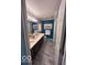 Hall bathroom featuring double sinks and framed mirrors at 2018 Alysheba Dr, Indianapolis, IN 46234