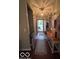 Welcoming foyer with hardwood floors, neutral walls, and stylish light fixture at 2018 Alysheba Dr, Indianapolis, IN 46234