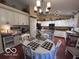 Bright eat-in kitchen features white cabinets, black appliances, and hardwood floors at 2018 Alysheba Dr, Indianapolis, IN 46234