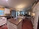 Open kitchen and dining area with white cabinets, hardwood floors, and stainless appliances at 2018 Alysheba Dr, Indianapolis, IN 46234