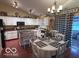 Eat-in kitchen features white cabinets, black appliances, and hardwood floors at 2018 Alysheba Dr, Indianapolis, IN 46234
