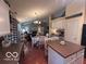 Open kitchen and dining area with white cabinets, hardwood floors, and stainless appliances at 2018 Alysheba Dr, Indianapolis, IN 46234