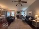 A cozy living room with a fireplace and a large rug at 2018 Alysheba Dr, Indianapolis, IN 46234