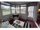 Enjoy your morning coffee in this sunroom with bright sunlight and charming decor at 2018 Alysheba Dr, Indianapolis, IN 46234