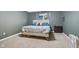 Calm and neutral bedroom featuring a comfortable bed, gray walls, and soft, plush carpeting at 2114 Turning Leaf Dr, Franklin, IN 46131