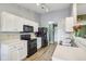 Bright kitchen with white cabinets, modern appliances, and contrasting black microwave and oven at 2114 Turning Leaf Dr, Franklin, IN 46131