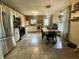 Spacious kitchen featuring stainless steel appliances, light cabinetry, dining table, and modern lighting at 2210 Bridlewood Dr, Franklin, IN 46131