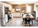 Eat-in kitchen features stainless steel appliances, wooden backsplash, and a door to the backyard at 2210 Bridlewood Dr, Franklin, IN 46131