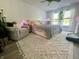 Bright bedroom with a large bed, cozy armchair, ceiling fan, and large windows that create a serene atmosphere at 2210 Bridlewood Dr, Franklin, IN 46131