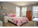 Bright bedroom with charming decor, a comfortable bed, and plenty of natural light from the windows at , Plainfield, IN 46168