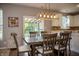 Cozy dining area with modern lighting, hardwood floors, and a view of the backyard at , Plainfield, IN 46168