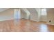 Finished attic showcasing hardwood floors and bright window at 2234 Burgundy Way, Plainfield, IN 46168