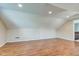 Bright, unfinished attic featuring hardwood floors and recessed lighting, ready for customization to your needs and desires at 2234 Burgundy Way, Plainfield, IN 46168