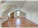 Finished attic showcasing hardwood floors and built-in cabinet at 2234 Burgundy Way, Plainfield, IN 46168