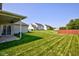 Expansive backyard featuring lush green grass, a well-maintained lawn, with houses surrounding it for privacy at 2234 Burgundy Way, Plainfield, IN 46168