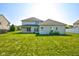 Expansive backyard featuring lush green grass, a well-maintained lawn, and a charming two-story home with a fenced perimeter at 2234 Burgundy Way, Plainfield, IN 46168