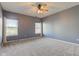 A carpeted bedroom featuring two windows, blinds, curtains, and a ceiling fan with a light at 2234 Burgundy Way, Plainfield, IN 46168