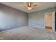 View of a bedroom featuring carpet, ceiling fan, lighting, and a doorway leading to another room at 2234 Burgundy Way, Plainfield, IN 46168