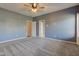 Spacious bedroom with neutral carpet, ceiling fan, and two doors leading to different rooms at 2234 Burgundy Way, Plainfield, IN 46168
