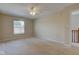 Spacious bedroom featuring neutral carpeting, a ceiling fan, and a bright window for natural light at 2234 Burgundy Way, Plainfield, IN 46168