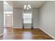 Neutral-toned dining room with hardwood floors, modern lighting, and large window at 2234 Burgundy Way, Plainfield, IN 46168