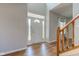Inviting foyer with hardwood floors, a staircase, and a bright front door with side windows at 2234 Burgundy Way, Plainfield, IN 46168