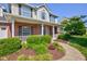 Close up of a charming two-story home with a manicured front garden and inviting front porch at 2234 Burgundy Way, Plainfield, IN 46168