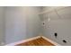 A light blue laundry room with a white wire rack, washer hookups, dryer vent, and wood flooring at 2234 Burgundy Way, Plainfield, IN 46168