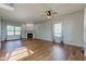 Spacious living room featuring a fireplace, ceiling fan, and large windows at 2234 Burgundy Way, Plainfield, IN 46168