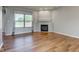 Cozy living room featuring a fireplace, large windows, and hardwood floors at 2234 Burgundy Way, Plainfield, IN 46168
