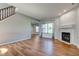 Inviting living room with hardwood floors, a fireplace, and large windows at 2234 Burgundy Way, Plainfield, IN 46168