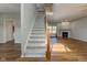 Bright open-concept floor plan, featuring hardwood floors, staircase, and a cozy fireplace at 2234 Burgundy Way, Plainfield, IN 46168