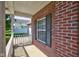 A close up of the exterior, with brick, black shutters and white porch railings at 2234 Burgundy Way, Plainfield, IN 46168