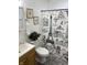 Bathroom with a charming Parisian-themed shower curtain, single sink vanity, and modern fixtures at 2608 S Rybolt Ave, Indianapolis, IN 46241
