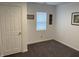 Bedroom featuring neutral walls, plush carpet, and a bright window for natural light at 2608 S Rybolt Ave, Indianapolis, IN 46241