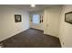 Bedroom with neutral paint, gray carpet and a white door at 2608 S Rybolt Ave, Indianapolis, IN 46241