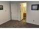 Bedroom with gray carpet leading into a bathroom with a wood vanity at 2608 S Rybolt Ave, Indianapolis, IN 46241