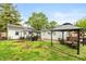 Backyard showcasing gazebos, patio furniture, detached garage, and lush greenery at 2704 13Th St, Columbus, IN 47201