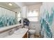Bathroom with white vanity, sink, and a shower-tub combo featuring a decorative shower curtain at 2704 13Th St, Columbus, IN 47201