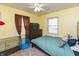Bedroom featuring light yellow walls, ceiling fan, and a window letting in natural light at 2704 13Th St, Columbus, IN 47201