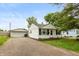 Cozy home with gravel driveway and detached garage, perfect for storage and projects at 2704 13Th St, Columbus, IN 47201