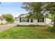 Charming single-story home with a manicured lawn and inviting front porch entrance at 2704 13Th St, Columbus, IN 47201
