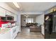 Open-concept kitchen with white cabinets and modern appliances, seamlessly connected to the living area at 2704 13Th St, Columbus, IN 47201