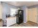 Cozy kitchen featuring gray walls, wood-look floors, and a black refrigerator at 2704 13Th St, Columbus, IN 47201