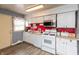 Bright kitchen with white cabinetry, modern appliances, and laminate flooring, perfect for cooking and gatherings at 2704 13Th St, Columbus, IN 47201