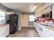 Functional kitchen with white appliances, laminate floors, and ample counter space, ready for your culinary adventures at 2704 13Th St, Columbus, IN 47201